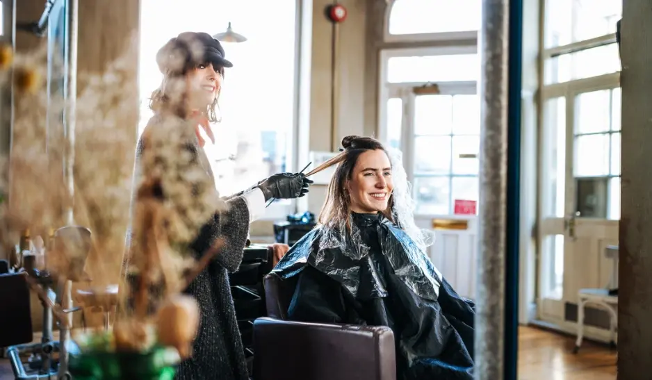 Hairstylist colouring a woman's hair